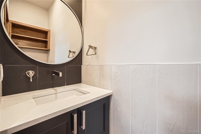 308 Creekside Aly Unit 5, Frisco, CO 80443 - bathroom with vanity, decorative backsplash, and wainscoting