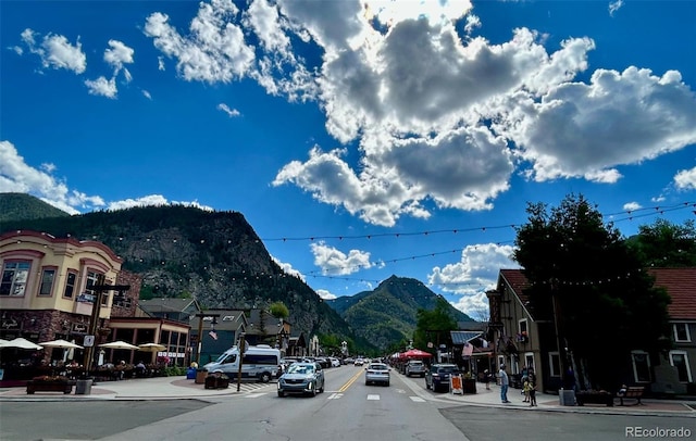 308 Creekside Aly Unit 5, Frisco, CO 80443 - view of asphalt street featuring a mountain view, sidewalks, curbs, and street lighting