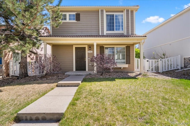 21562 E 47th Ave, Denver, CO 80249 - view of front of house with covered porch, fence, and a front yard
