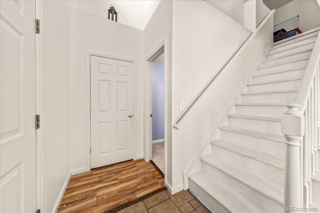 21562 E 47th Ave, Denver, CO 80249 - staircase featuring tile patterned flooring and baseboards
