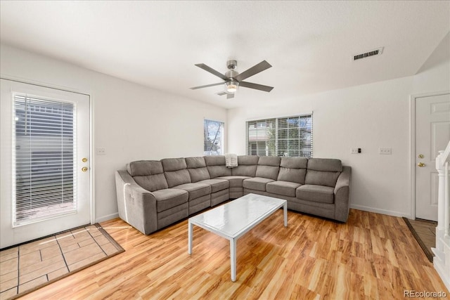 21562 E 47th Ave, Denver, CO 80249 - living room with light wood-style floors, visible vents, baseboards, and a ceiling fan