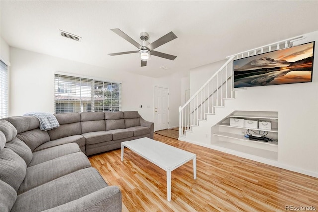 21562 E 47th Ave, Denver, CO 80249 - living area with wood finished floors, visible vents, baseboards, ceiling fan, and stairs