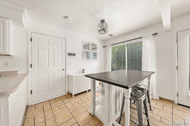 21562 E 47th Ave, Denver, CO 80249 - kitchen with white cabinetry, a chandelier, baseboards, and visible vents