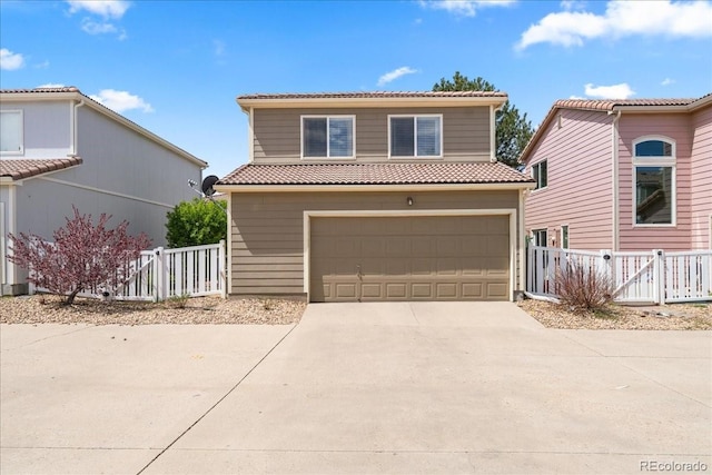 21562 E 47th Ave, Denver, CO 80249 - view of front of property featuring concrete driveway, a tiled roof, a garage, and fence