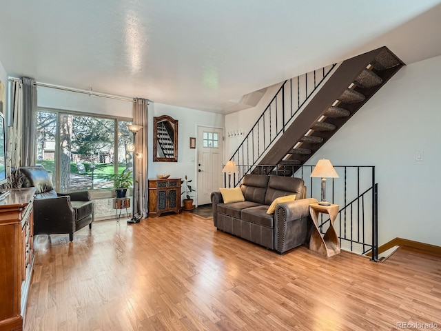 4273 W Ponds Cir, Littleton, CO 80123 - living room featuring wood finished floors, stairs, and baseboards