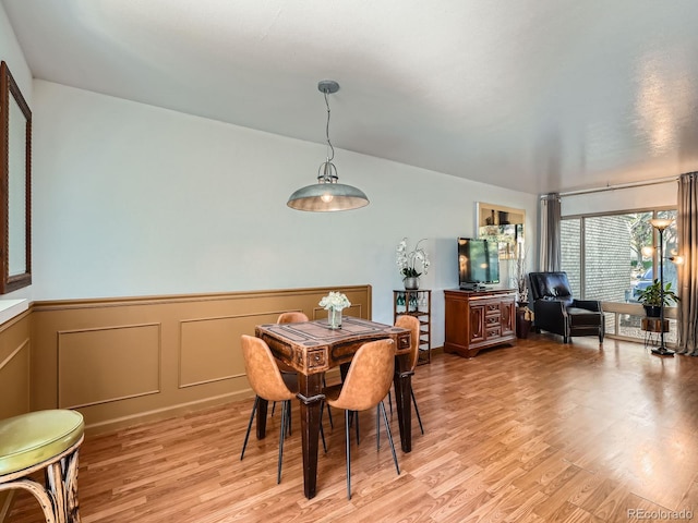 4273 W Ponds Cir, Littleton, CO 80123 - dining room with light wood-type flooring, a wainscoted wall, and a decorative wall