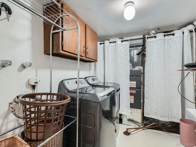 4273 W Ponds Cir, Littleton, CO 80123 - clothes washing area featuring cabinet space and washing machine and clothes dryer