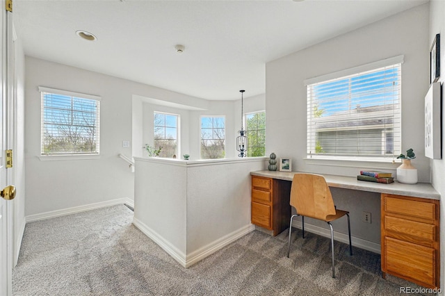 14025 Blue River Trl, Broomfield, CO 80023 - office area featuring built in study area, dark carpet, and baseboards