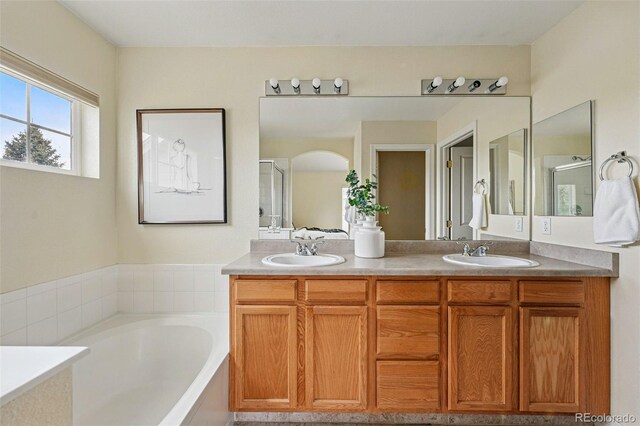 14025 Blue River Trl, Broomfield, CO 80023 - bathroom featuring double vanity, a bath, and a shower stall