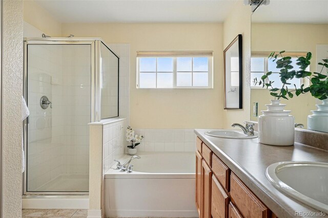 14025 Blue River Trl, Broomfield, CO 80023 - full bath featuring a garden tub, a stall shower, double vanity, and tile patterned floors