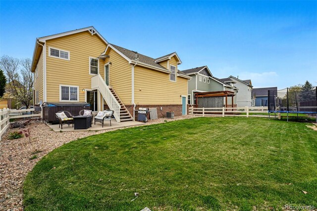 14025 Blue River Trl, Broomfield, CO 80023 - back of property with a trampoline, a patio, central AC, and stairway