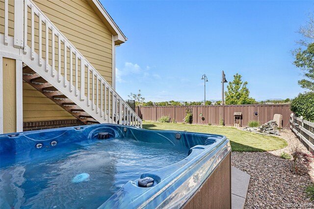 14025 Blue River Trl, Broomfield, CO 80023 - view of pool with stairway, a fenced backyard, and a hot tub