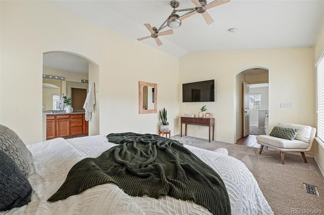 14025 Blue River Trl, Broomfield, CO 80023 - bedroom with arched walkways, light colored carpet, baseboards, vaulted ceiling, and ceiling fan