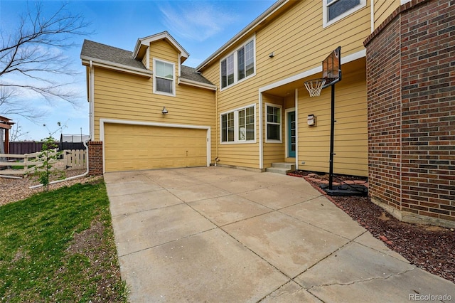 14025 Blue River Trl, Broomfield, CO 80023 - back of house with a garage, concrete driveway, and a shingled roof