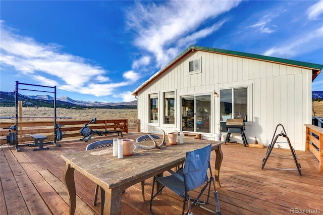 wooden terrace with a mountain view and a grill