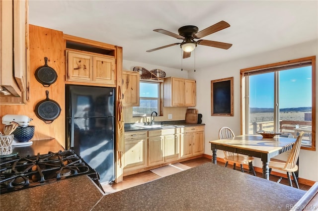 kitchen with black appliances, ceiling fan, sink, and light brown cabinetry