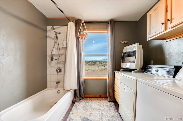 interior space featuring washer and dryer, shower / bath combo, and heating unit