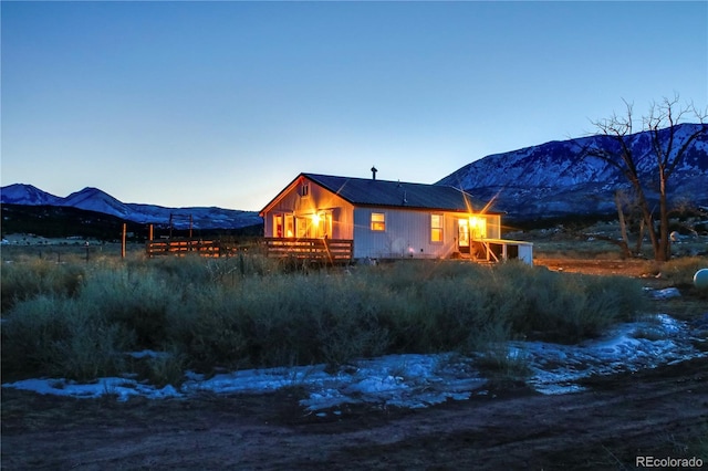 snow covered house featuring a mountain view