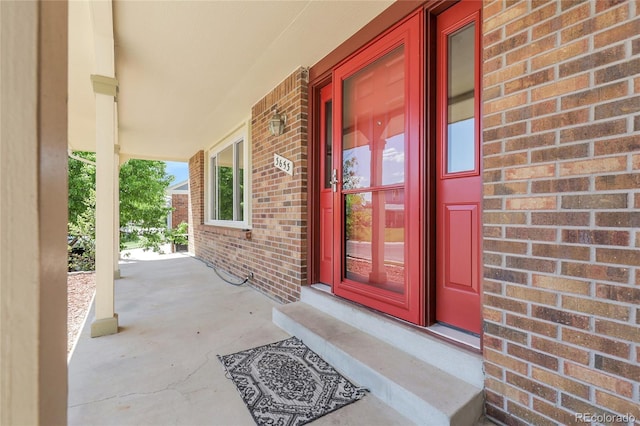 3653 E 133rd Ct, Thornton, CO 80241 - doorway to property featuring brick siding and a porch