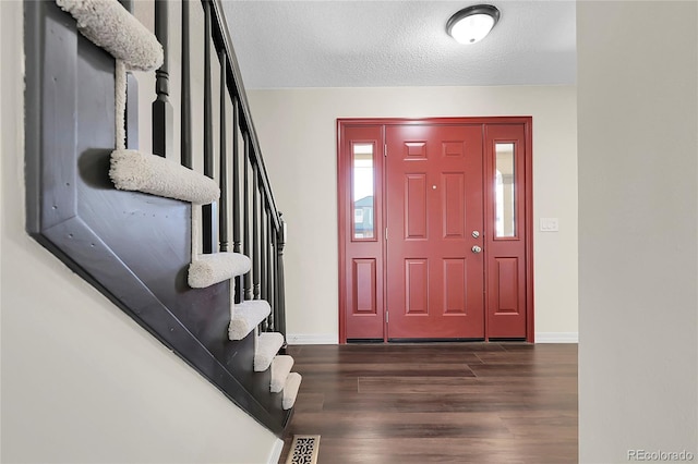 3653 E 133rd Ct, Thornton, CO 80241 - foyer with dark wood-style flooring, stairs, a textured ceiling, and baseboards