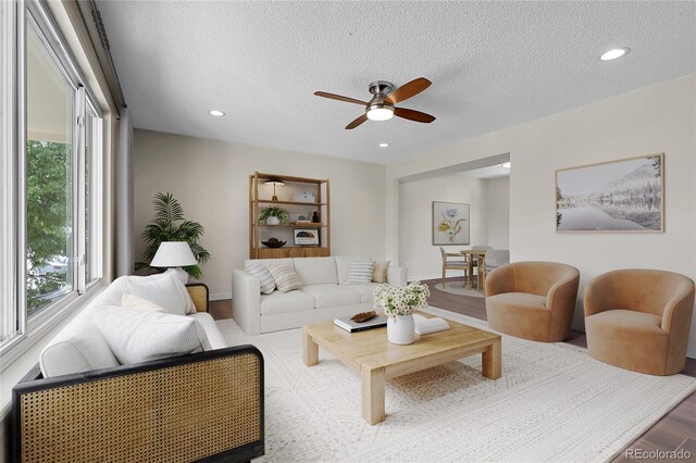 3653 E 133rd Ct, Thornton, CO 80241 - living room with ceiling fan, a textured ceiling, baseboards, wood finished floors, and recessed lighting