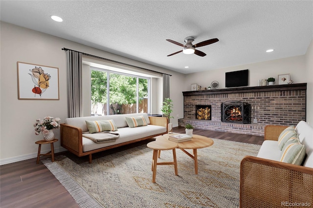 3653 E 133rd Ct, Thornton, CO 80241 - living room with wood finished floors, a ceiling fan, a fireplace, a textured ceiling, and baseboards