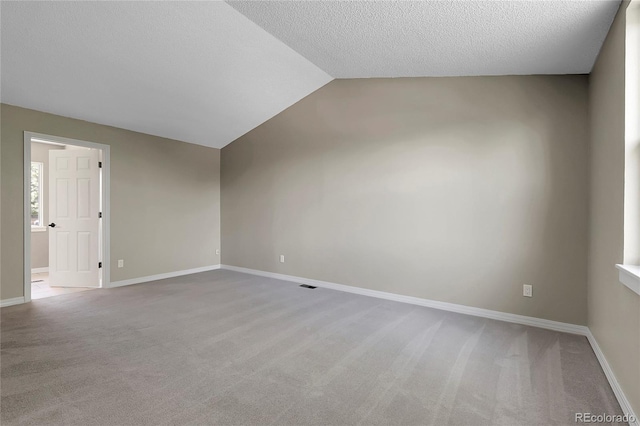 3653 E 133rd Ct, Thornton, CO 80241 - unfurnished room featuring light colored carpet, lofted ceiling, baseboards, and a textured ceiling