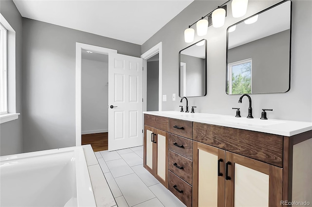3653 E 133rd Ct, Thornton, CO 80241 - full bathroom with double vanity, a bathtub, and tile patterned flooring