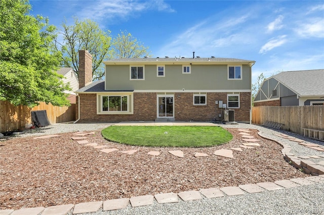 3653 E 133rd Ct, Thornton, CO 80241 - rear view of house featuring central AC unit, brick siding, a fenced backyard, and a patio area