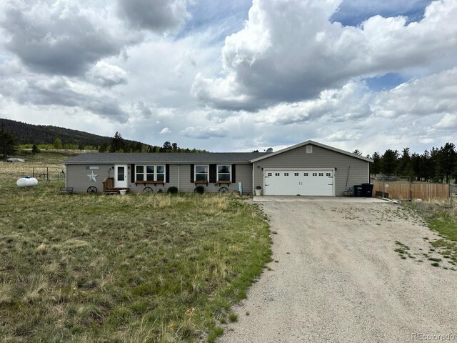 1326 Kaufman Rd, Hartsel, CO 80449 - ranch-style house featuring a garage and dirt driveway