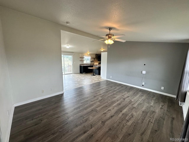 1326 Kaufman Rd, Hartsel, CO 80449 - unfurnished living room featuring dark wood-style flooring, baseboards, a ceiling fan, and a textured ceiling