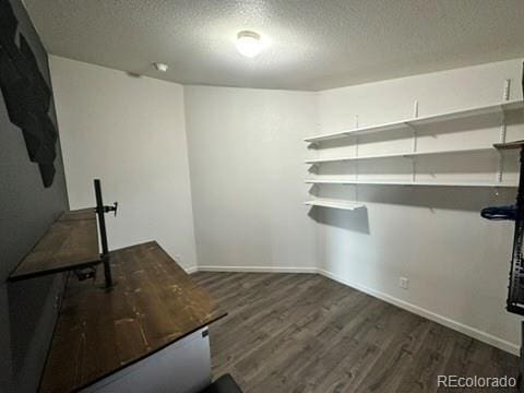1326 Kaufman Rd, Hartsel, CO 80449 - unfurnished office featuring a textured ceiling, dark wood-style flooring, and baseboards