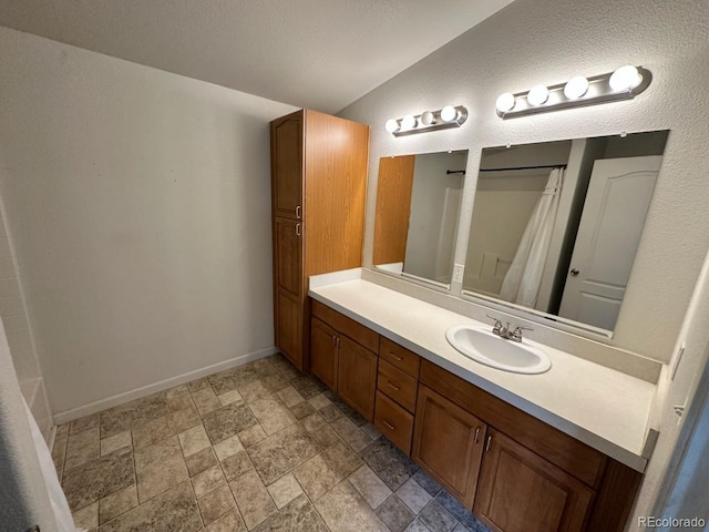 1326 Kaufman Rd, Hartsel, CO 80449 - full bath featuring vanity, stone finish flooring, baseboards, and a shower with shower curtain