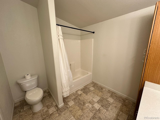 1326 Kaufman Rd, Hartsel, CO 80449 - bathroom featuring toilet, baseboards, lofted ceiling, shower / bath combo with shower curtain, and stone finish floors