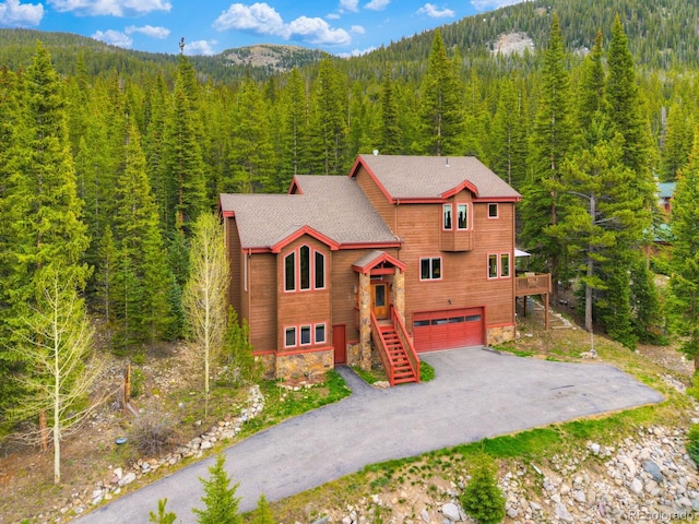 322 Davis Ct, Breckenridge, CO 80424 - chalet / cabin with a view of trees, a garage, asphalt driveway, a mountain view, and stairway