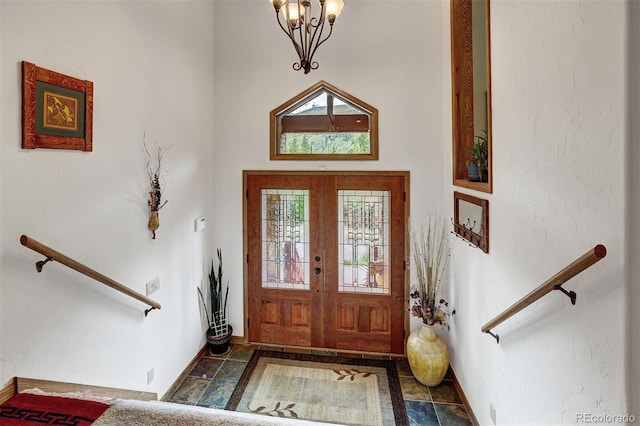 322 Davis Ct, Breckenridge, CO 80424 - foyer with healthy amount of natural light, stone finish flooring, a chandelier, and a towering ceiling