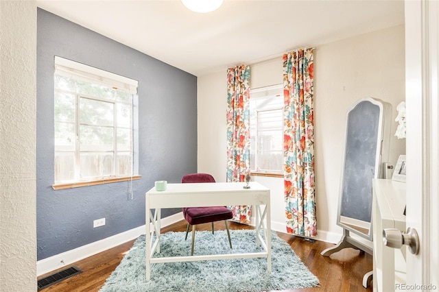 office space with dark hardwood / wood-style flooring and a wealth of natural light