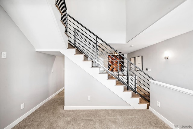 stairway with carpet and baseboards