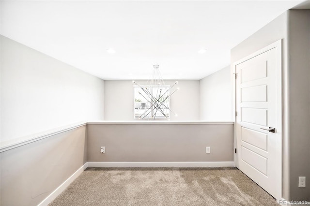 carpeted empty room with baseboards