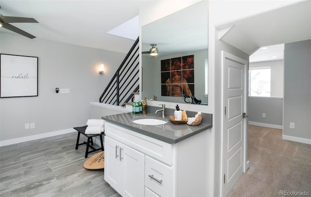 bathroom featuring ceiling fan, vanity, and baseboards