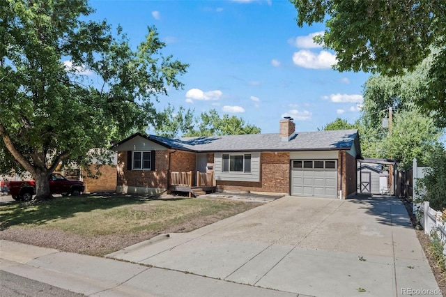 1035 Iris St, Broomfield, CO 80020 - ranch-style house with brick siding, a garage, a storage unit, concrete driveway, and a front yard