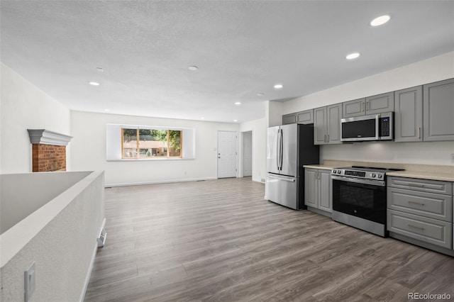 1035 Iris St, Broomfield, CO 80020 - kitchen with appliances with stainless steel finishes, gray cabinets, dark wood-style floors, light countertops, and recessed lighting