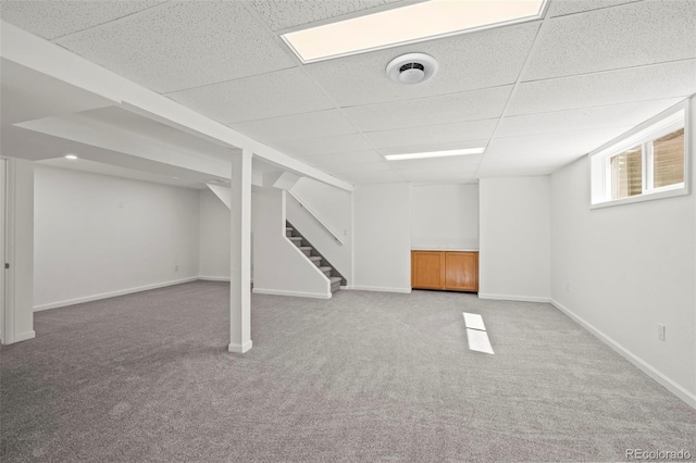 1035 Iris St, Broomfield, CO 80020 - below grade area featuring carpet flooring, a drop ceiling, and stairway