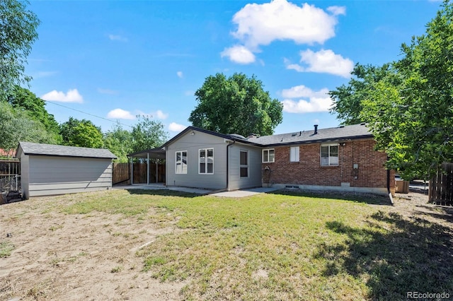 1035 Iris St, Broomfield, CO 80020 - rear view of house with a patio, a fenced backyard, brick siding, and an outdoor structure