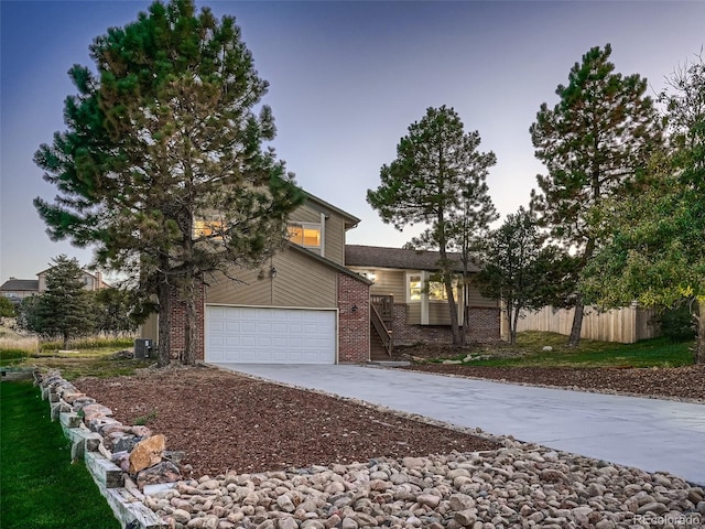 8916 Sunridge Hollow Rd, Parker, CO 80134 - view of front facade featuring brick siding, a garage, fence, and driveway