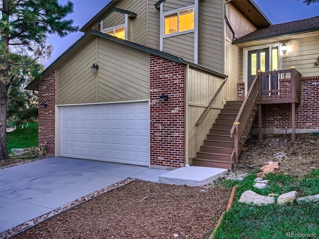 8916 Sunridge Hollow Rd, Parker, CO 80134 - view of property exterior featuring brick siding, a garage, driveway, and stairway