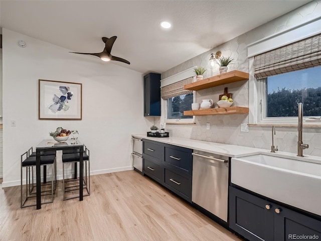 8916 Sunridge Hollow Rd, Parker, CO 80134 - kitchen featuring ceiling fan, a sink, light wood-style flooring, tasteful backsplash, and stainless steel dishwasher