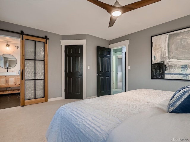 8916 Sunridge Hollow Rd, Parker, CO 80134 - carpeted bedroom with a ceiling fan, ensuite bath, and a barn door