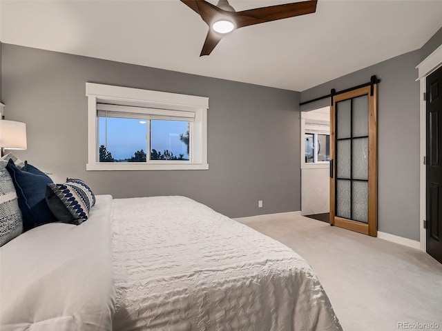 8916 Sunridge Hollow Rd, Parker, CO 80134 - bedroom featuring ceiling fan, a barn door, baseboards, and carpet