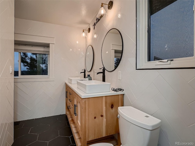 8916 Sunridge Hollow Rd, Parker, CO 80134 - bathroom featuring tile walls, tile patterned flooring, vanity, and toilet